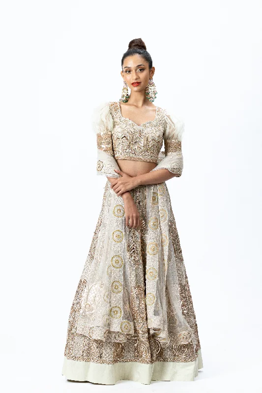 Beige Hand-embroidered Lehenga paired with Puff-sleeved Hand-embroidered Blouse and Hand-embroidered Dupatta with buttis Chic Ruffle Blouse Beige Hand-embroidered Lehenga paired with Puff-sleeved Hand-embroidered Blouse and Hand-embroidered Dupatta with buttis Chic Ruffle Blouse